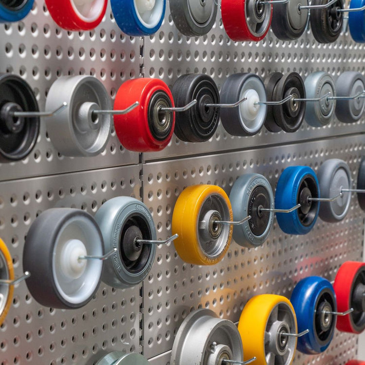 A wide range of colorful high quality wheels in stock on a peg board display